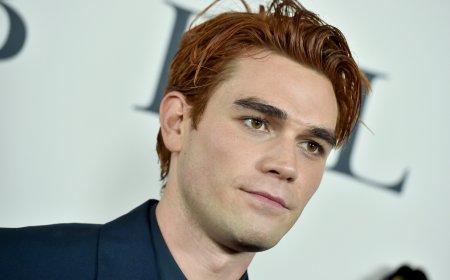 KJ Apa leaves little to the imagination chasing after a dog in his underwear