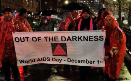 Advocates brave the rain at 32nd Out of the Darkness vigil on World AIDS Day