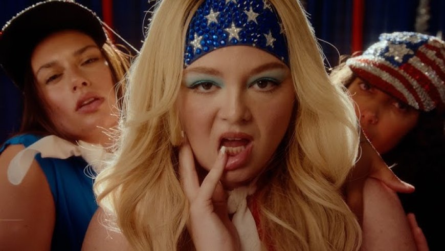 Meg Stalter’s ‘Prettiest Girl In America’ Video Is The Exact, Campy Joyride We Need Right Now